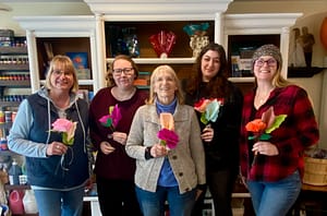 Friends holding handmade paper flowers after a Craft Cottage class in Grafton NH