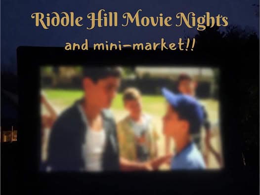 Outdoor movie screen at dusk during Riddle Hill Movie Nights & Mini Market in Grafton, New Hampshire, featuring a family-friendly movie under the stars.