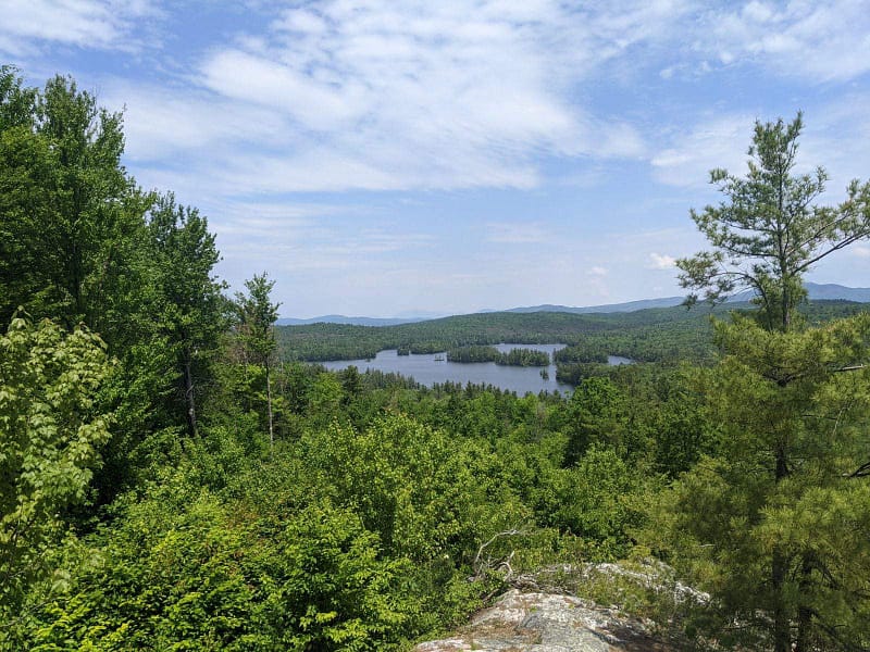 Grafton Pond seen from above surrounded by forest in Grafton, New Hampshire